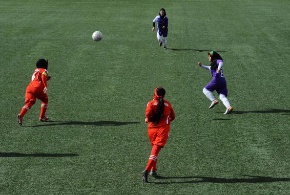 Afghan female football players from Isteghlal (in purple) and Afghan (red) compete during the women&#039;s football tournament final match in Kabul on December 6, 2013. 