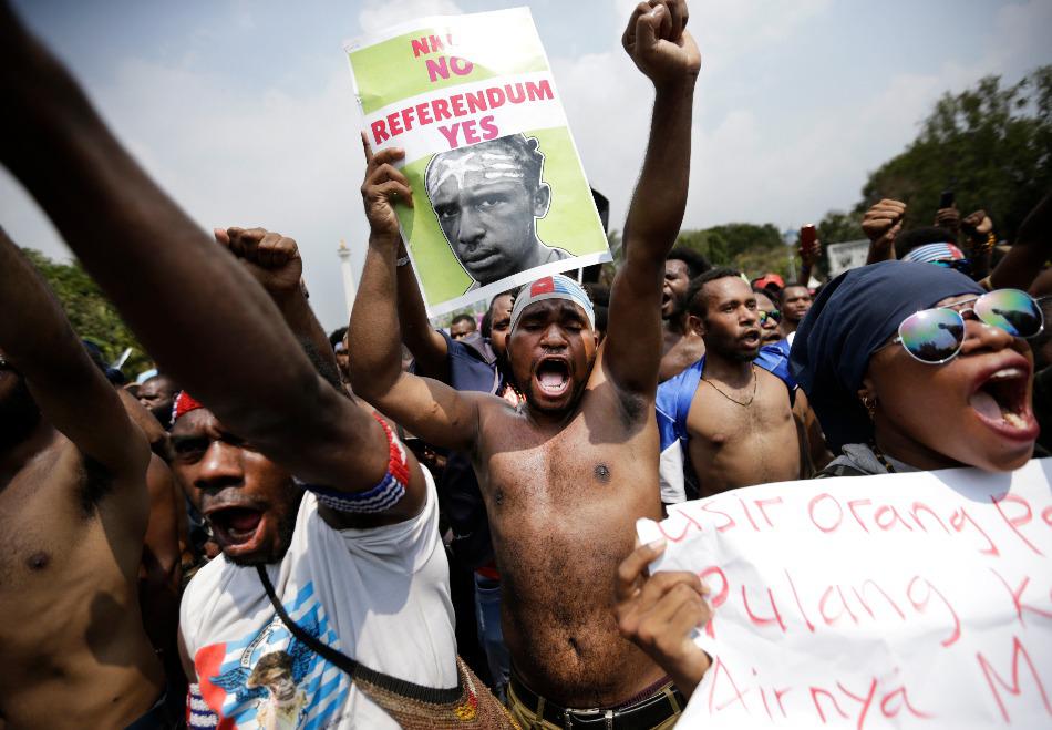 Papuan activists shout slogans during a rally near the presidential palace in Jakarta, Indonesia.