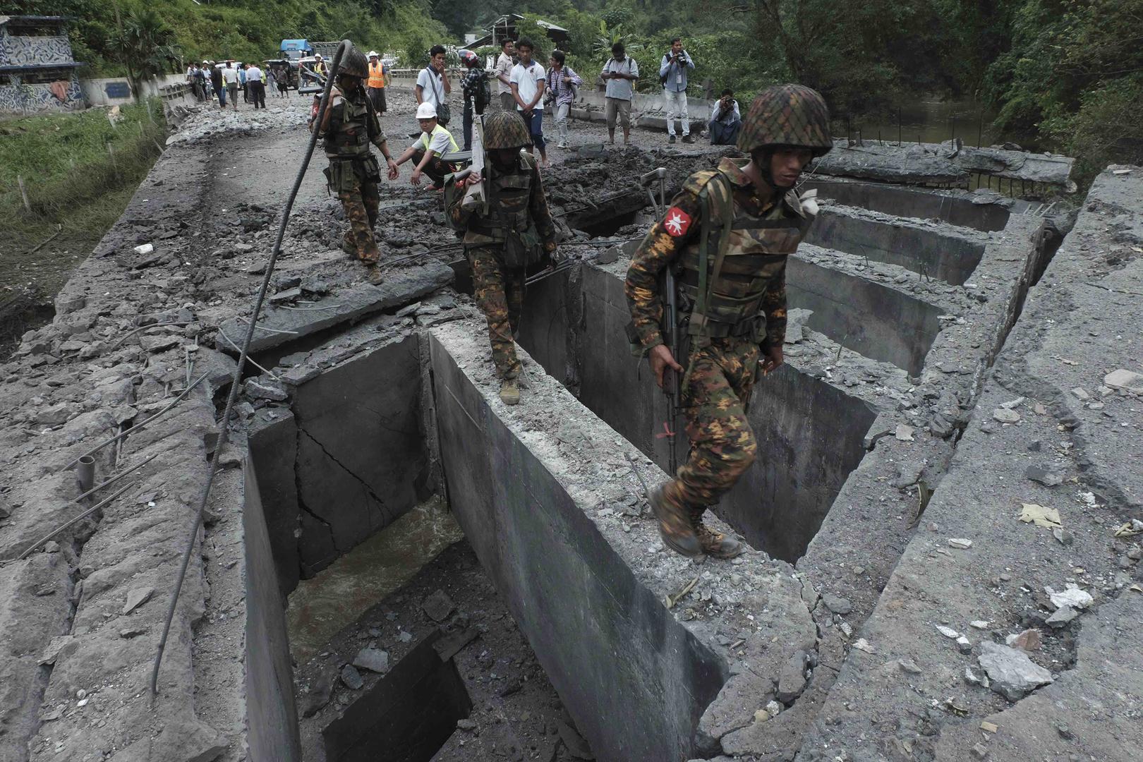 Soldiers walk over the Goktwin bridge, damaged by an explosion, in Nawnghkio, northern Shan State, Myanmar, August 15, 2019.