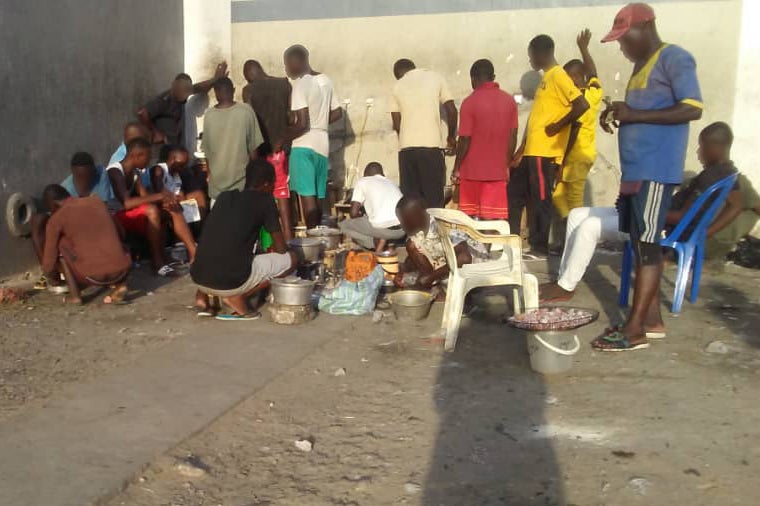 Detainees prepare food in a courtyard in Makala prison, Kinshasa, Democratic Republic of Congo, in March 2020.