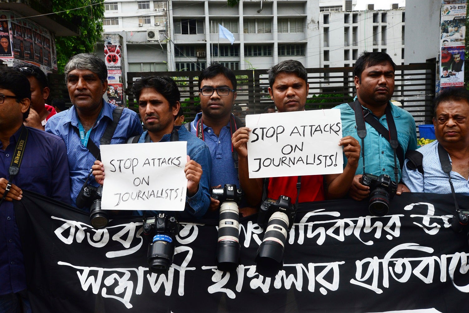 Bangladeshi photojournalists and journalists form a human chain infront of National Press Club protesting the attacks on them during the students' ongoing protest demanding safe roads, in Dhaka, Bangladesh on August 7, 2018.