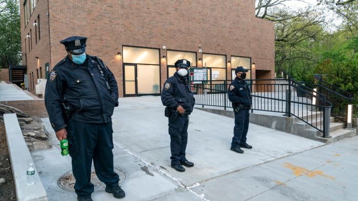 Police stand guard in front of the Young Israel of Riverdale synagogue where glass windows were smashed in New York on April 25, 2021.