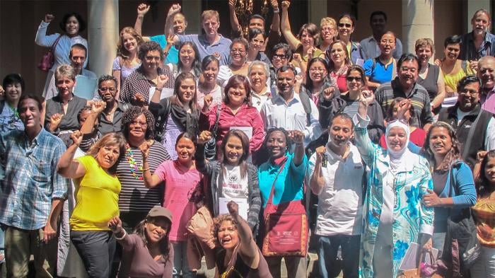 Domestic worker activists raising their fists in the air