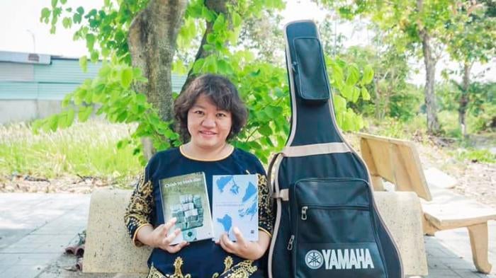 Pham Doan Trang with two books that she co-authored, 2019.