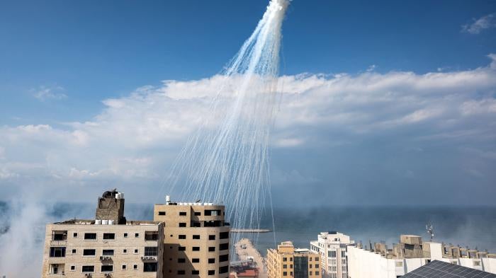 Airbursts of artillery-fired white phosphorus fall over the Gaza city port, October 11, 2023. 
