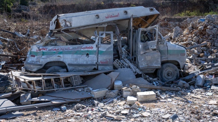 An ambulance lies destroyed in the rubble of an Israeli airstrike in Kafra, Lebanon on October 9, 2024.