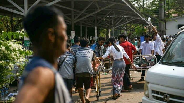 Medical workers transport an earthquake casualty at a hospital