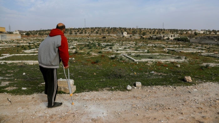 Nidal Ahmad stands near his olive farm in Aleppo, Syria on March 4, 2025. Its location near a former Syrian Army military camp has prevented him from harvesting crops for years. Last December, Nidal returned to check on his land and lost his foot in a landmine explosion. 
