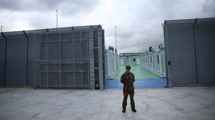A member of the Italian Army stands in front of an immigration detention camp built by Italy in Gjader, Albania, October 11, 2024. 