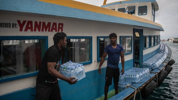 Bottled water is loaded onto a boat for delivery to another island in Malé, Maldives, December 18, 2019.