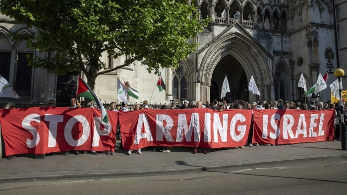Activists hold a banner at a demonstration outside the Royal Courts of Justice in London, UK, May 13, 2025. 