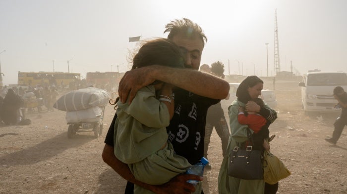 Afghan returnees cross the border from Iran, on July 3, 2025, in Islam Qala, Afghanistan. 