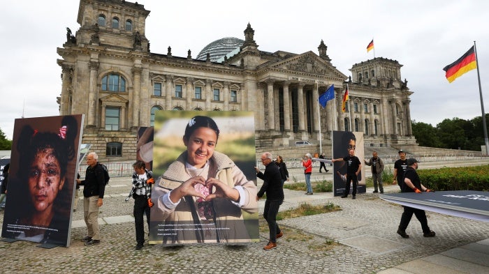 Activists set up pictures of children from Gaza in front of the Reichstag building during a protest calling for greater commitment of the German government to the children of Gaza and the defense of international law, in Berlin, Germany, July 9, 2025.