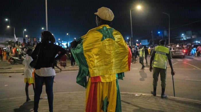 A supporter wears the Senegalese national flag in Dakar