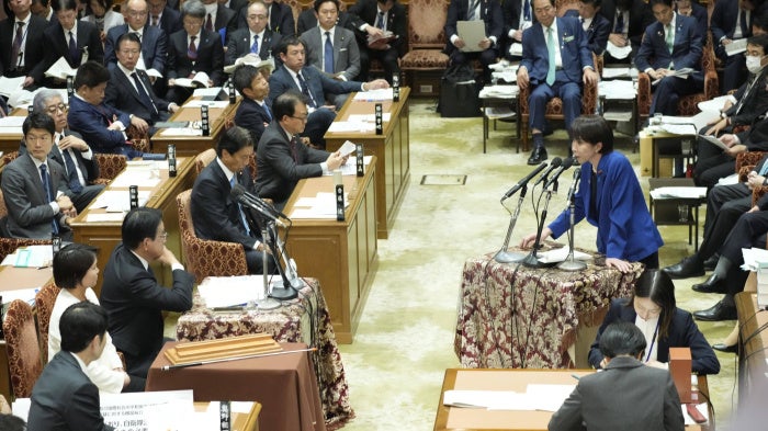 Japanese Prime Minister Sanae Takaichi (R) answers questions from the House of Representatives budget committee in Tokyo, November 7, 2025. 