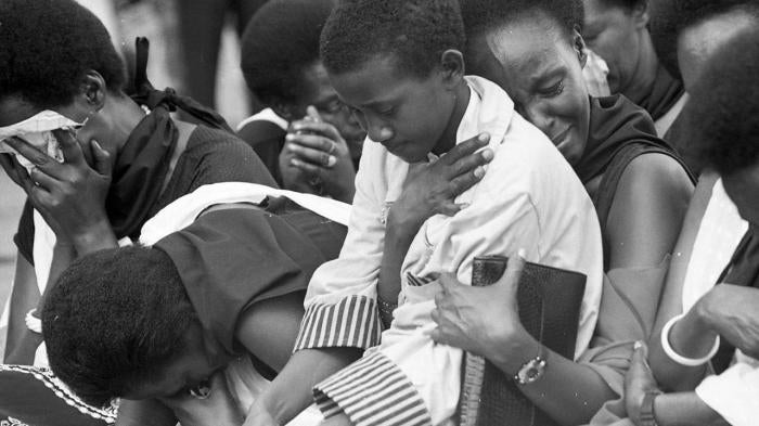 Relatives of victims of the genocide grieve during a memorial event.