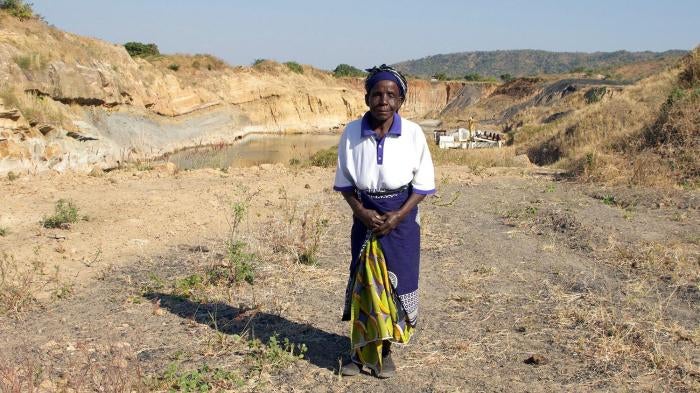 Nagomba E., 75, standing where her house used to be in Mwabulambo, Karonga district. She and her family were told to relocate in 2008 because the land was needed for coal mining. 