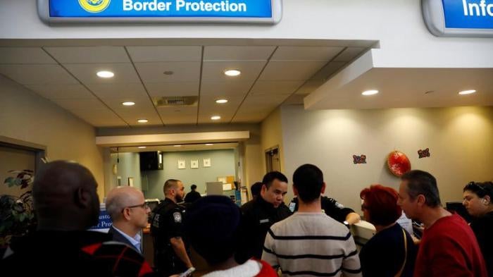 U.S. Customs and Border Protection officers stand outside an office during the travel ban at Los Angeles International Airport (LAX) in Los Angeles, California, U.S., January 28, 2017.