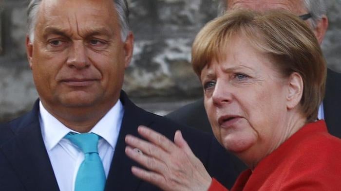 Germany's Chancellor Angela Merkel talks with Hungary's Prime Minister Viktor Orban before a photo at the European Union Tallinn Digital Summit in Tallinn, Estonia, September 29, 2017. 