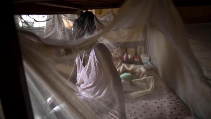 A woman from Cameroon sits with her baby in a private shelter in Lagos, Nigeria.