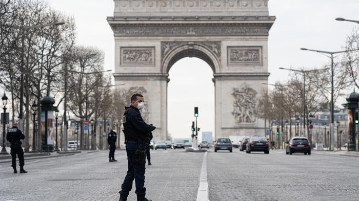 Police patrol near the Arc de Triomphe on the first day of confinement due to COVID-19, Paris, France, March 17, 2020.