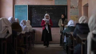 An Afghan girl reads in a classroom at Tajrobawai Girls High School, in Herat, Afghanistan, November 25, 2021.