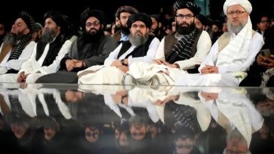 Taliban leaders sit in a row at a ceremony