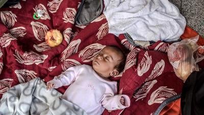 A Syrian baby sleeps on the floor inside the Keleti train station in Budapest, Hungary on August 31, 2015. 