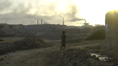 A child walks in a brick kiln in Afghanistan.