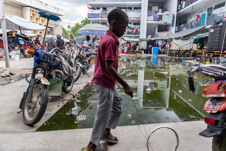 A child plays with a circle in the courtyard of a refugee camp, where people have fled to escape violence from criminal groups, in the Bas Delmas neighborhood of Port-au-Prince, Haiti, May 2, 2024.
