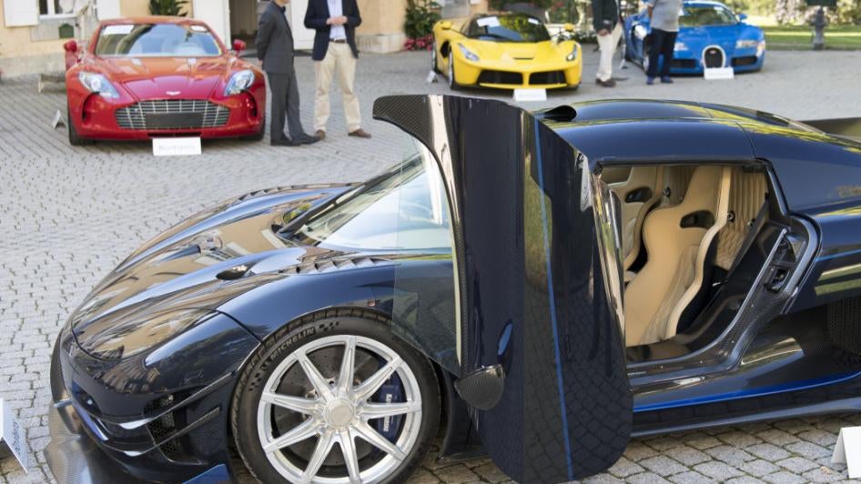 People looking at luxury cars owned by Teodoro Obiang, son of Equatorial Guinea's President Teodoro Obiang Nguema Mbasogo, before an auction of sales house Bonhams at the Bonmont Abbey Golf & Country Club near Geneva, Switzerland, September 29, 2019.