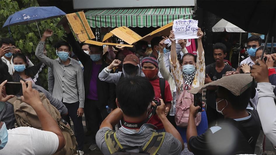 Supporters of Rong Chhun, president of the Cambodian Confederation of Unions, shout slogans in front of Phnom Penh Municipal Court in Phnom Penh, Cambodia on Saturday, August 1, 2020. 