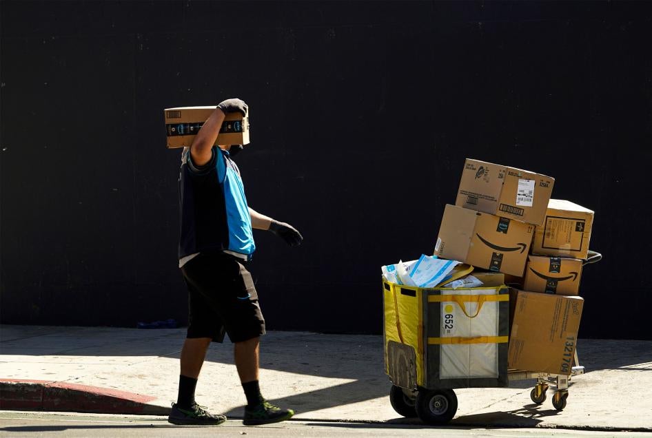 An Amazon worker delivers boxes in downtown Los Angeles, California, October 1, 2020. 