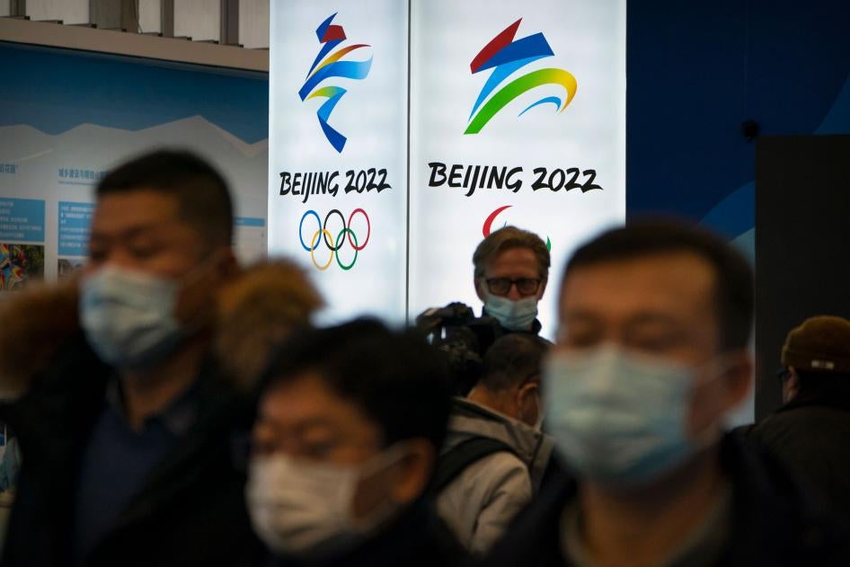 Attendees wearing face masks look at an exhibit at a visitors center at the Winter Olympic venues in Yanqing on the outskirts of Beijing, February 5, 2021.