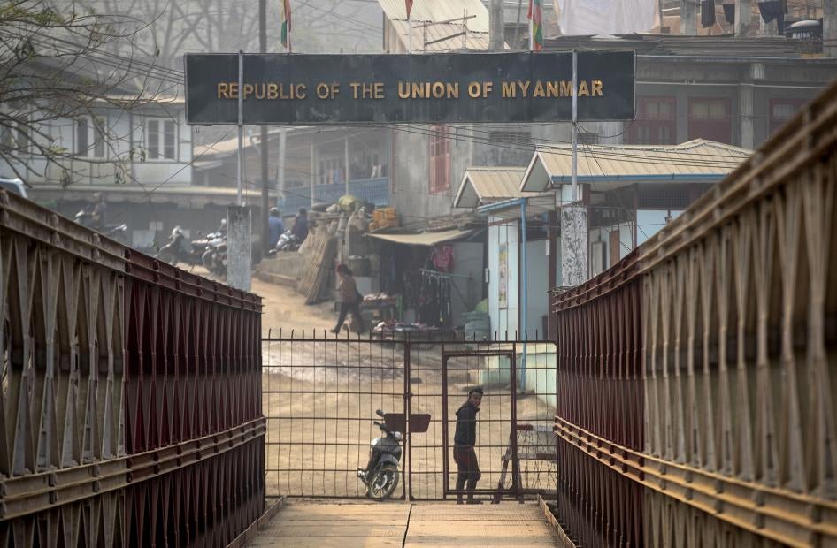 A Myanmarese man looks towards the Indian side at the India-Myanmar border in Mizoram, India, Saturday, March 20, 2021. 