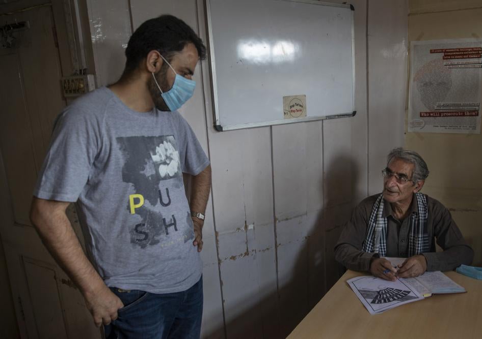 Khurram Parvez, a prominent human rights activist, left, in the office of the Jammu and Kashmir Coalition of Civil Society in Srinagar, India, August 25, 2020. 