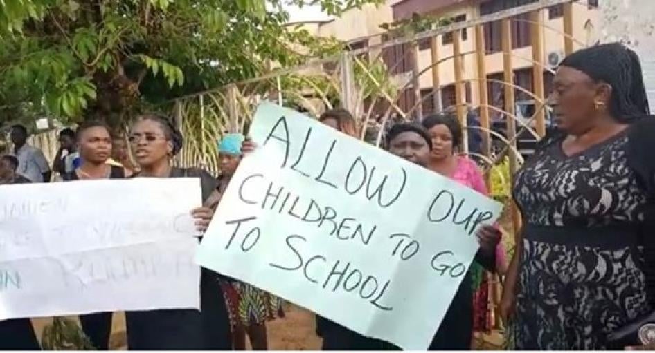Women protesters holding signs