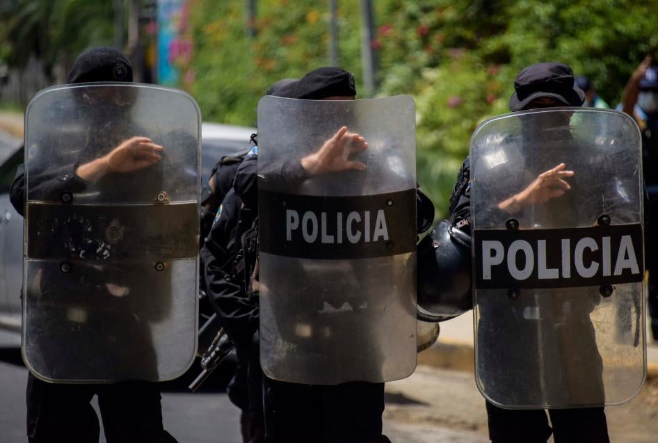 Riot police stand guard outside the house of Cristiana Chamorro, former director of the Violeta Barrios de Chamorro Foundation and opposition presidential candidate, in Managua on June 2, 2021, the day Nicaraguan police raided her home without a warrant and placed her under house arrest.