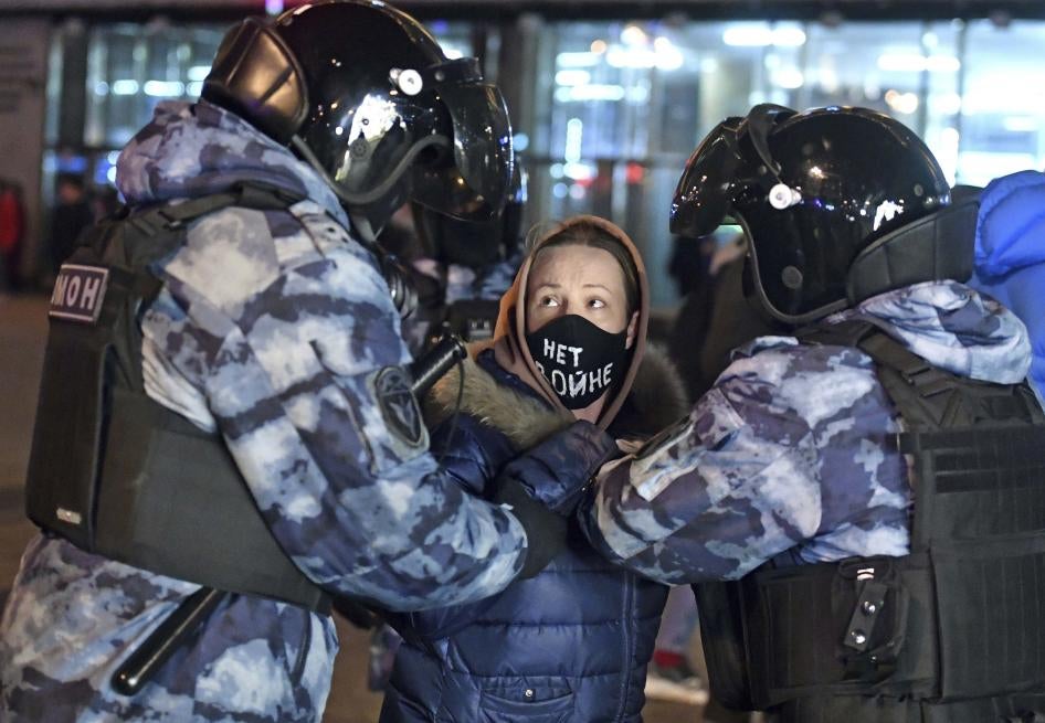 Police officers detain a protestor on Pushkin Square.