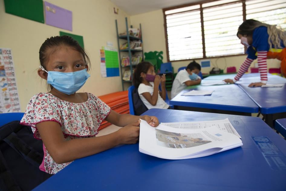 A child wears a face mask in a classroom