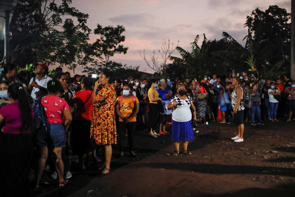 People wait for news of the release of relatives detained during the state of emergency in El Salvador, at the security perimeter of the Izalco prison in Izalco, El Salvador, on April 28, 2022.