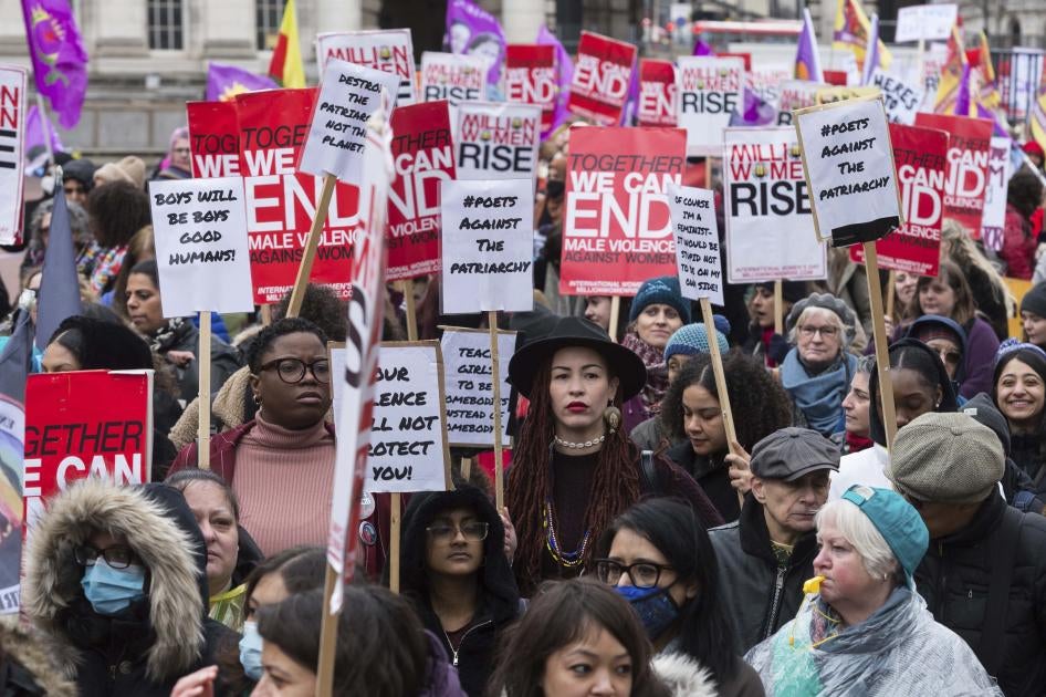 Women hold placards at the Million Women Rise march in London ahead of International Women's Day on March 05, 2022. 