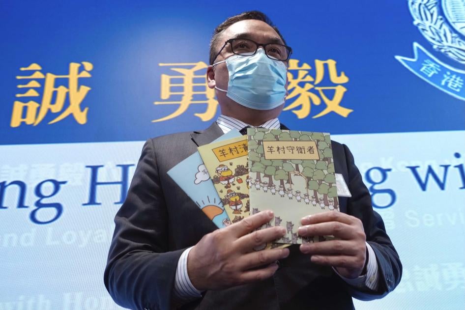 Li Kwai-wah, senior superintendent of Police National Security Department, poses with the children's book series Sheep Village at a press conference in Hong Kong, July 22, 2021.