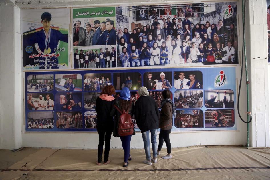 Jiu Jitsu club members look at a wall with posters at their club ahead of a training session in Kabul, Afghanistan, Saturday, Feb. 15, 2020.