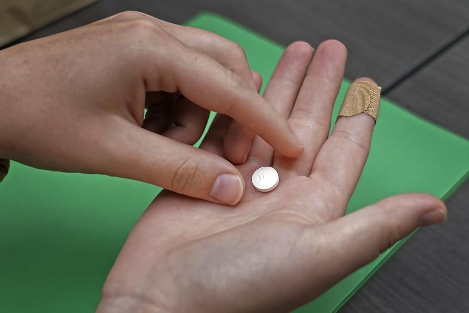 A patient in a Kansas clinic prepares to take the first of two pills for a medical abortion.