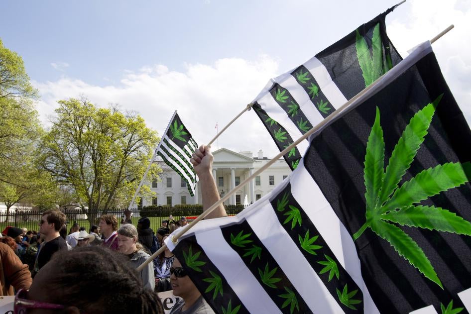 A demonstrator waves a flag during a protest calling for the legalization of marijuana, outside of the White House in Washington, DC, US.