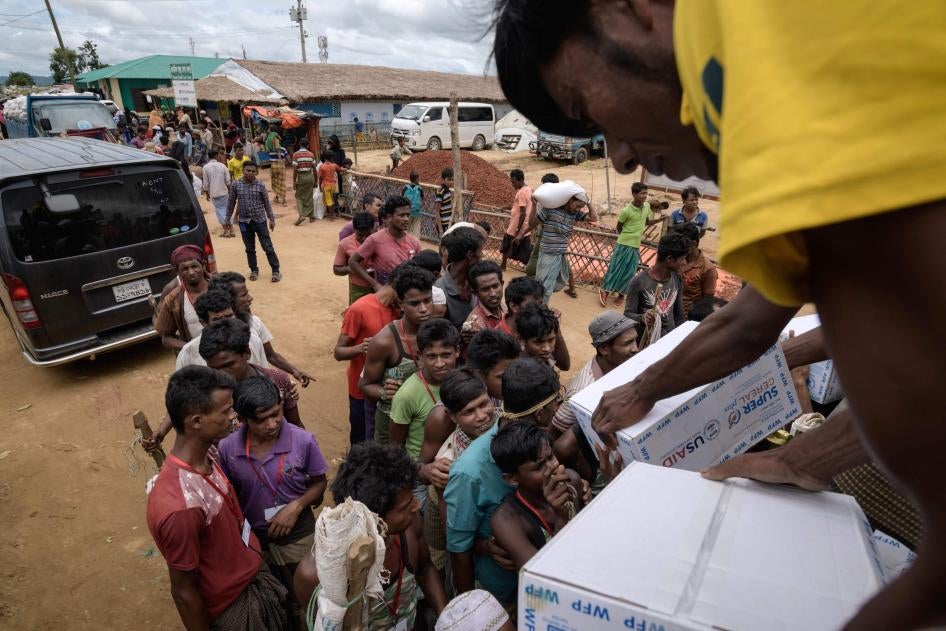 Rohingya refugees collect boxes of food aid at a distribution point in the Kutupalong camp near Cox's Bazar, Bangladesh, August 14, 2018.