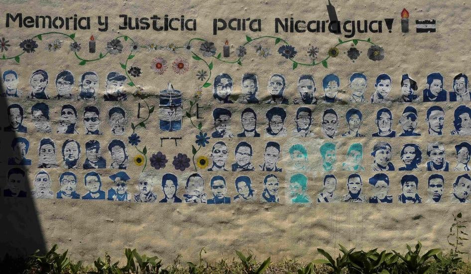 A mural showing images of Nicaraguans killed during the 2018 social security reform protests under the words “memory and justice for Nicaragua”  adorns a wall at the Nicaragua Nunca Más human rights organization in San Jose, Costa Rica, February 20, 2023.