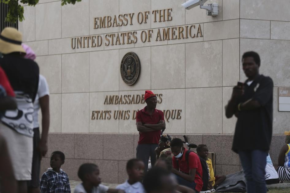 People displaced by armed gangs from their homes in the Tabare neighborhood rest outside the U.S. embassy in Port-au-Prince, Haiti, July 25, 2023. 