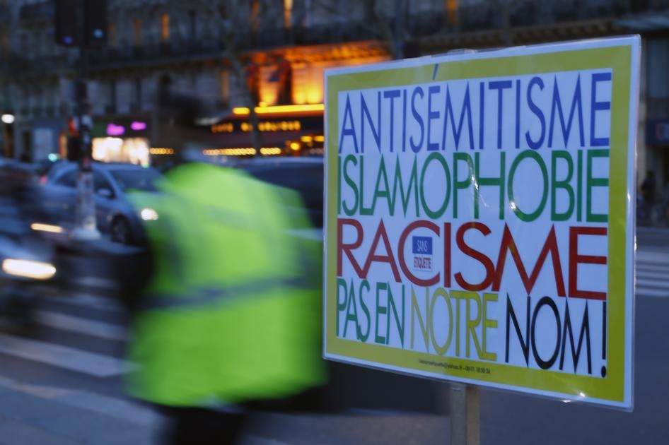 A poster reading "Anti-Semitism, Islamophobia, Racism, Not in Our Name" during a gathering decrying anti-semitism at Place de la Republique in Paris, February 18, 2019.